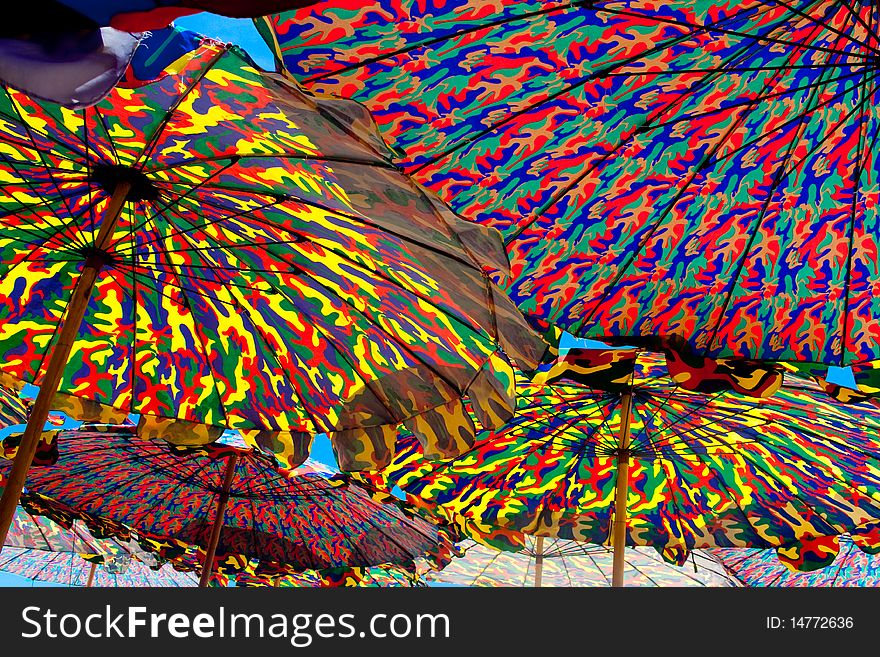 Under colurful umbrella on the beach of Thailand