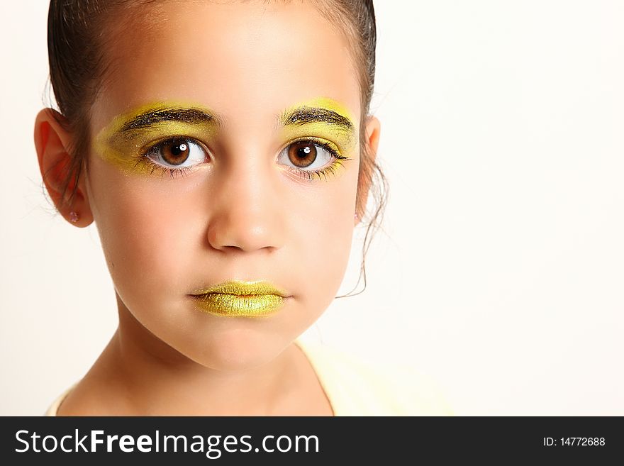 Beautiful six year old girl in bright yellow make-up.