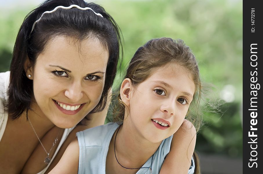 Portrait of happy mother with daughter having good time in summer environment. Portrait of happy mother with daughter having good time in summer environment