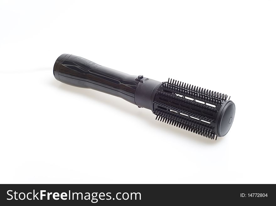 Black curling tongs on the white background