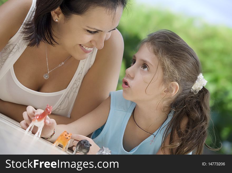 Portrait of happy mother with daughter  having good time in summer environment. Portrait of happy mother with daughter  having good time in summer environment