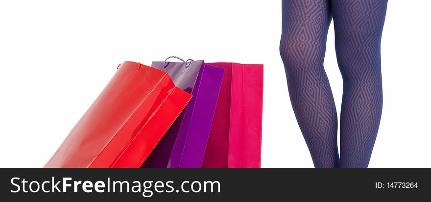 Shopping bags and woman legs wearing panties isolated on white background. Shopping concept. Shopping bags and woman legs wearing panties isolated on white background. Shopping concept.