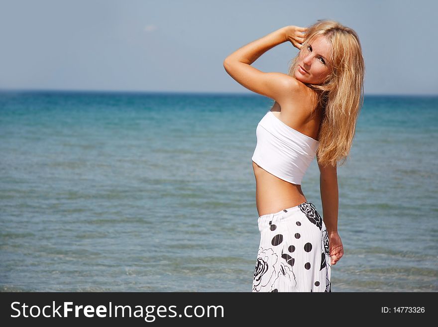 Young beautiful woman on sea background