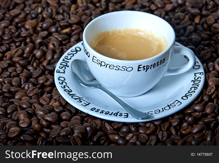 White cup of espresso with roasted coffee beans. White cup of espresso with roasted coffee beans