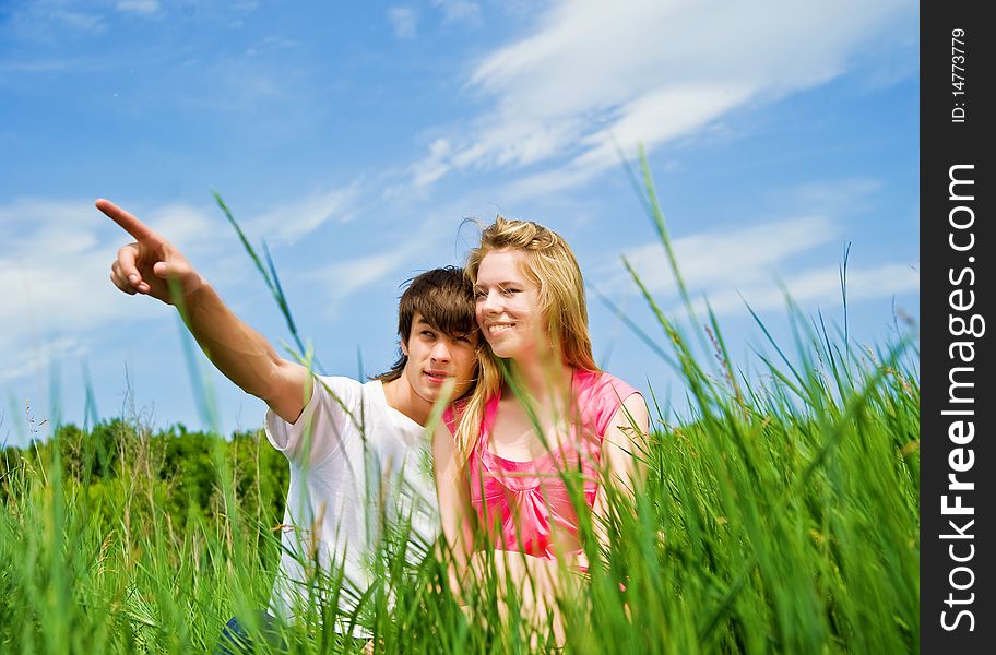 Couple sit in a grass