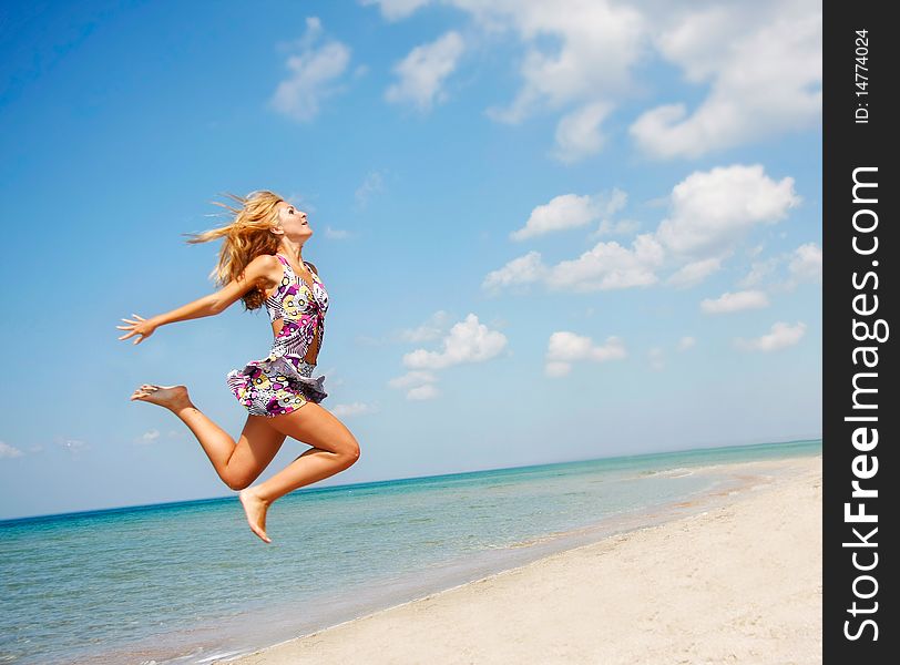 Young attractive girl jumping on beach. Young attractive girl jumping on beach