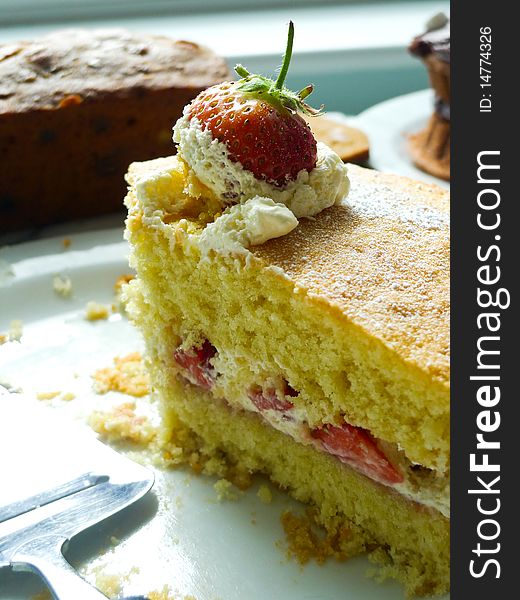 A delicious home made slice of cream cake with strawberry. A delicious home made slice of cream cake with strawberry