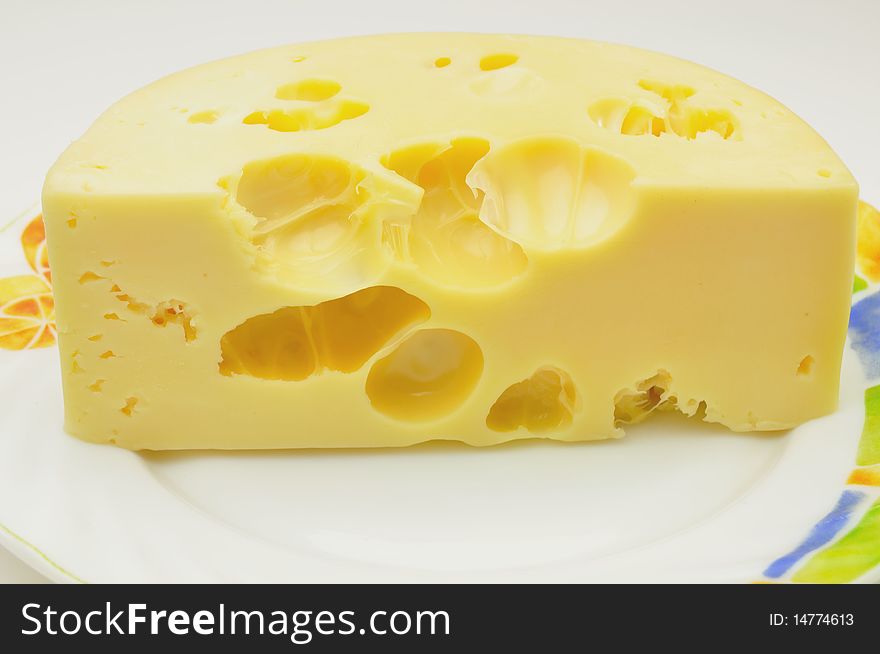 Piece of cheese on a plate. Piece of cheese on a plate