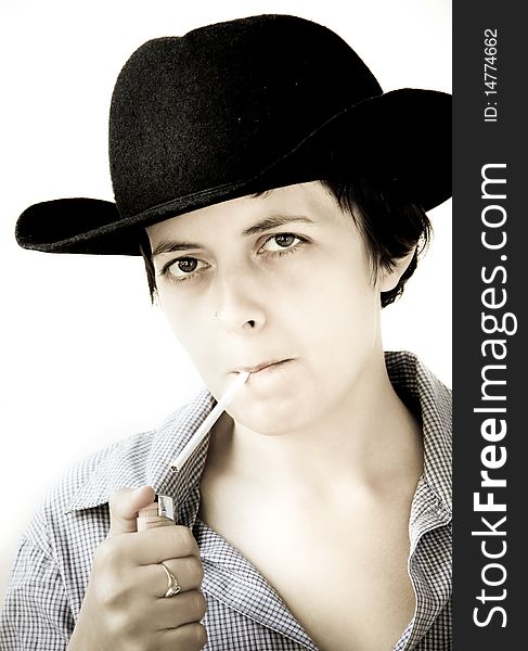 Woman with black hat lighting a cigarette. Woman with black hat lighting a cigarette
