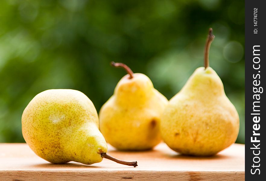 Fresh pears against green background