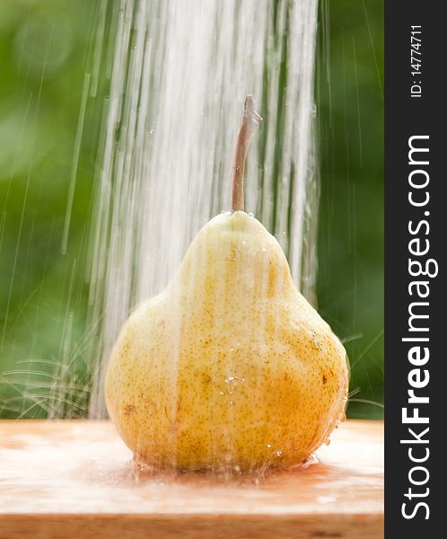 Pear washed under flowing water. Pear washed under flowing water