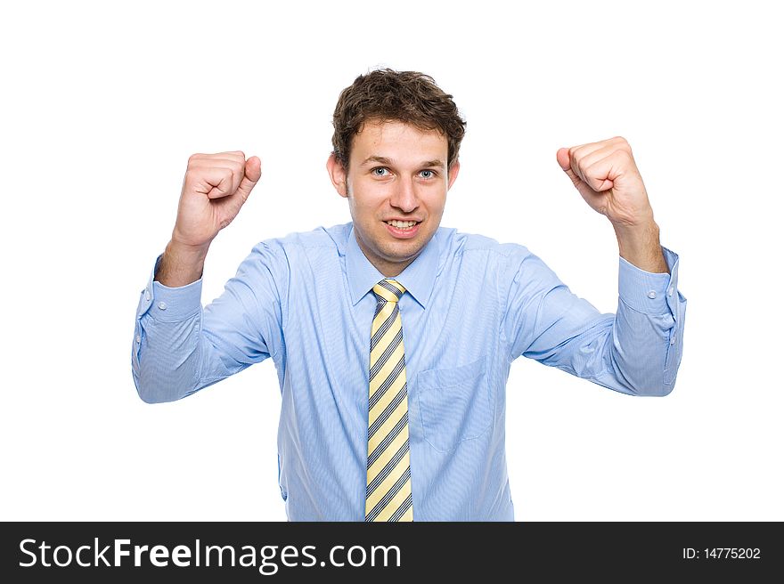 Young businessman in his 20s, wears blue shirt with yellow necktie, holds arms up celebrate success, studio shoot isolated on white background. Young businessman in his 20s, wears blue shirt with yellow necktie, holds arms up celebrate success, studio shoot isolated on white background