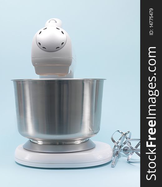 A food mixer isolated against a blue background