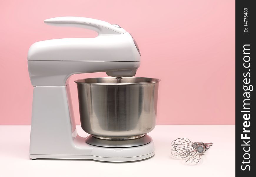 A food mixer isolated against a blue background