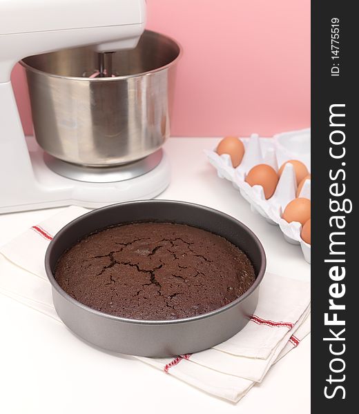 A baked chocolate cake on a kitchen bench