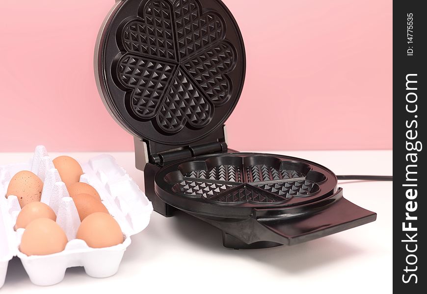 A waffle iron on a kitchen bench