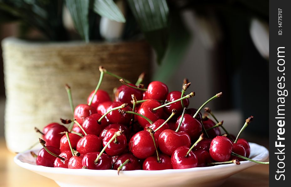 A group of cherries in a plate. A group of cherries in a plate.