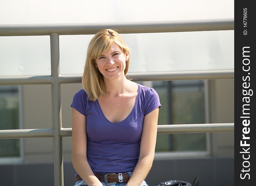 Portrait of a smiling student in the street