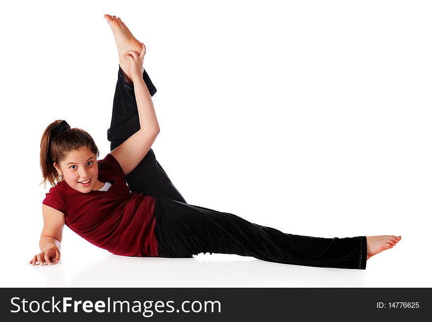 A reclining happy preteen lifting one leg far over her head.  Isolated on white. A reclining happy preteen lifting one leg far over her head.  Isolated on white.
