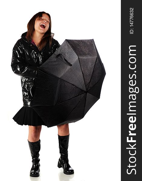 A happy teen girl in a raincoat and boots, singing with an opened umbrella. isolated on white. A happy teen girl in a raincoat and boots, singing with an opened umbrella. isolated on white.