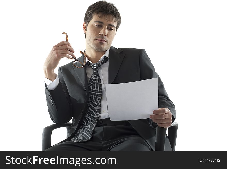 Businessman analyzing document, white background