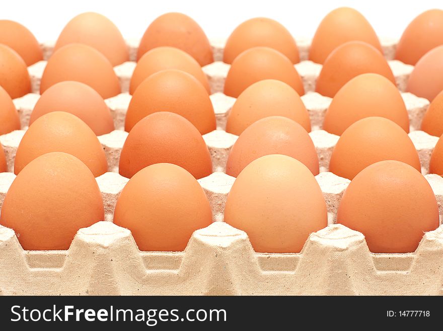 Rows of brown eggs in a protective container