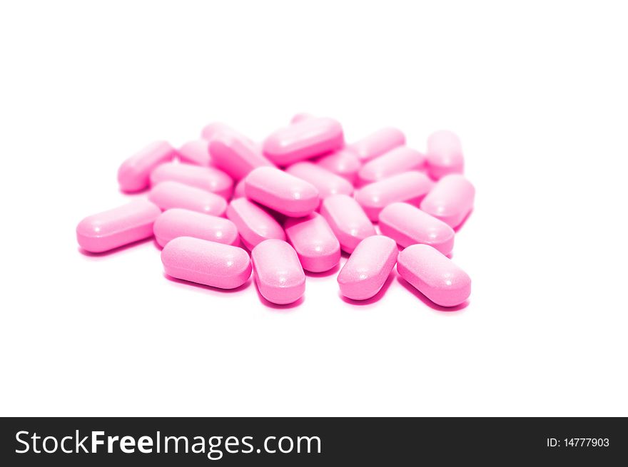 Photo of the pink pills on white background