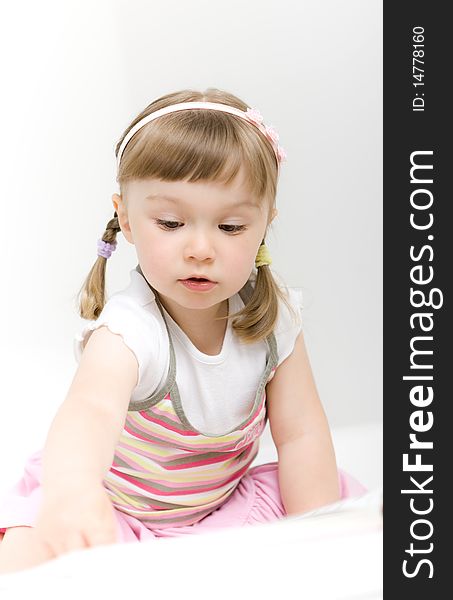 Sweet happy little girl reading book