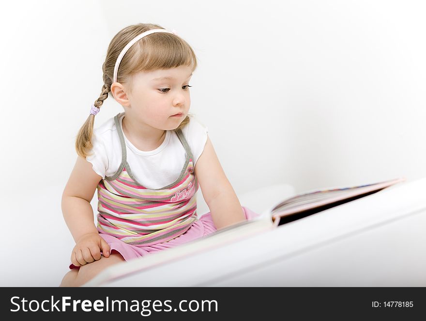 Little girl reading book