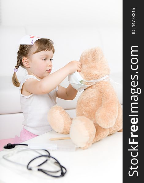 Sweet little girl doctor with teddy bear