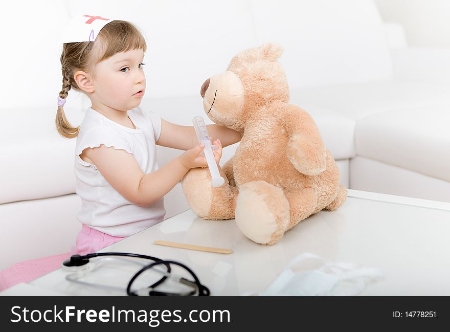 Little girl doctor with teddy bear