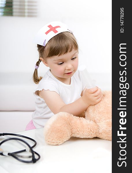Sweet little girl doctor with teddy bear