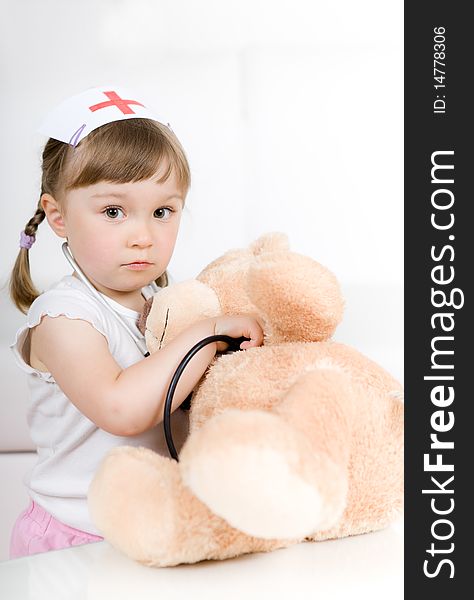 Little girl doctor with teddy bear