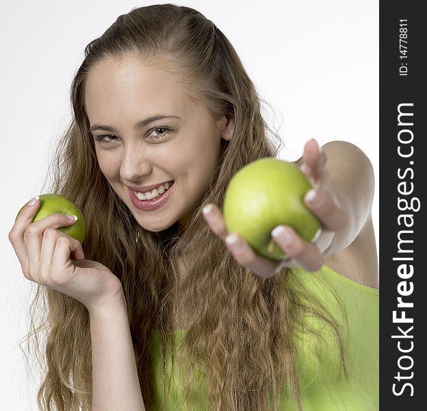 Portrait of young woman with apples
