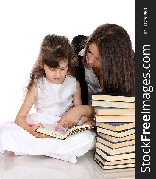 Two sisters with books, on a white background, it is isolated. Two sisters with books, on a white background, it is isolated.