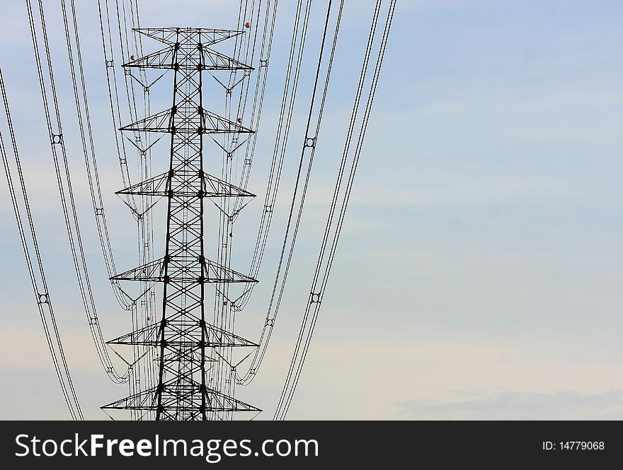 Electric power station in the field in blue cloudy sky