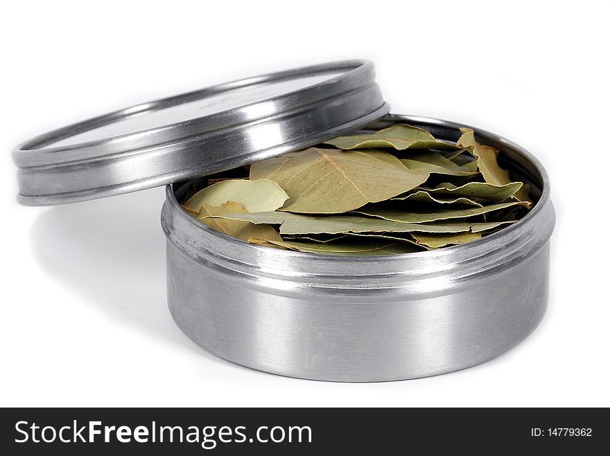 Bay leafs in metal box on white background