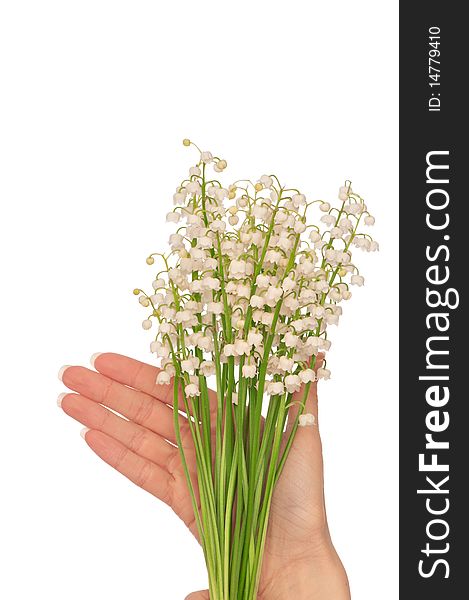 Woman holding lily of the valley in the hand