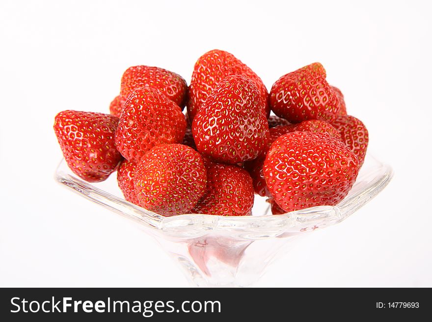 Strawberries in a glass cup on white background. Strawberries in a glass cup on white background