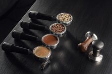 Four Holders With Green, Roasted, Ground, And Hot Coffee And Tamper, Equipment For Making Freshly Brewed Coffee Stock Images Four Holders With Green, Roasted, Ground, And Hot Coffee And Tamper, Equipment For Making Freshly Brewed Coffee Stock Images