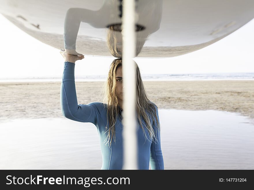 Pretty Surf girl with a longboard on the beach