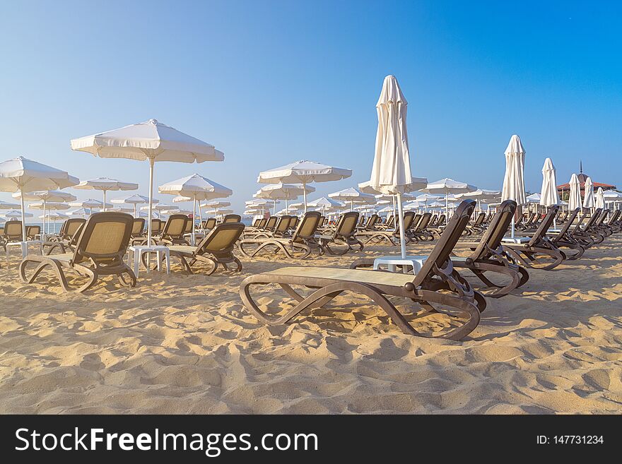 Chairs and umbrellas on a beautiful beach at sunrise in Sunny Beach on the Black Sea coast of Bulgaria