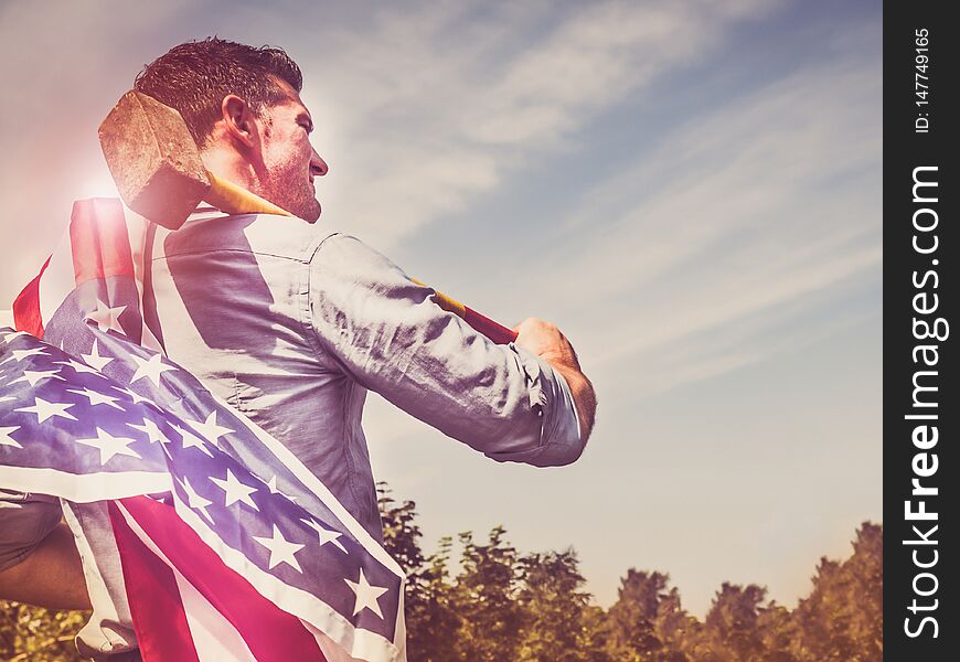 Attractive man holding a hammer and US Flag