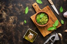 Pesto Sauce, Basil Leaves, Garlic And Olive Oil On A Dark Rustic Background. Overhead View,copy Space Royalty Free Stock Images