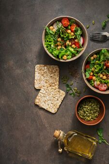 A Bowl Of Vegan And Vegetarian Fresh Vegetable Salad And Chickpeas On A Dark Background. Top View, Copy Space Stock Photography