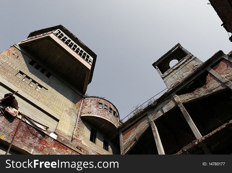 Old and abandoned factory with gray sky above