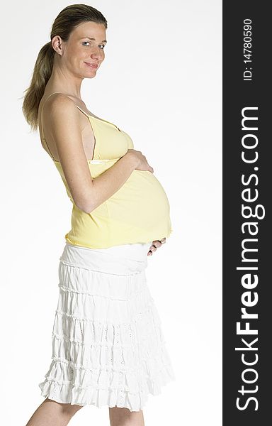 Standing pregnant woman holding her belly