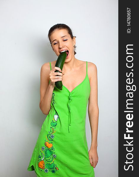 Young girl in green dress with squash zucchini. Young girl in green dress with squash zucchini