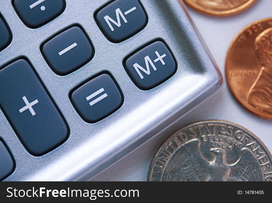 Close up on a calculator's keyboard with some coins around. Close up on a calculator's keyboard with some coins around.