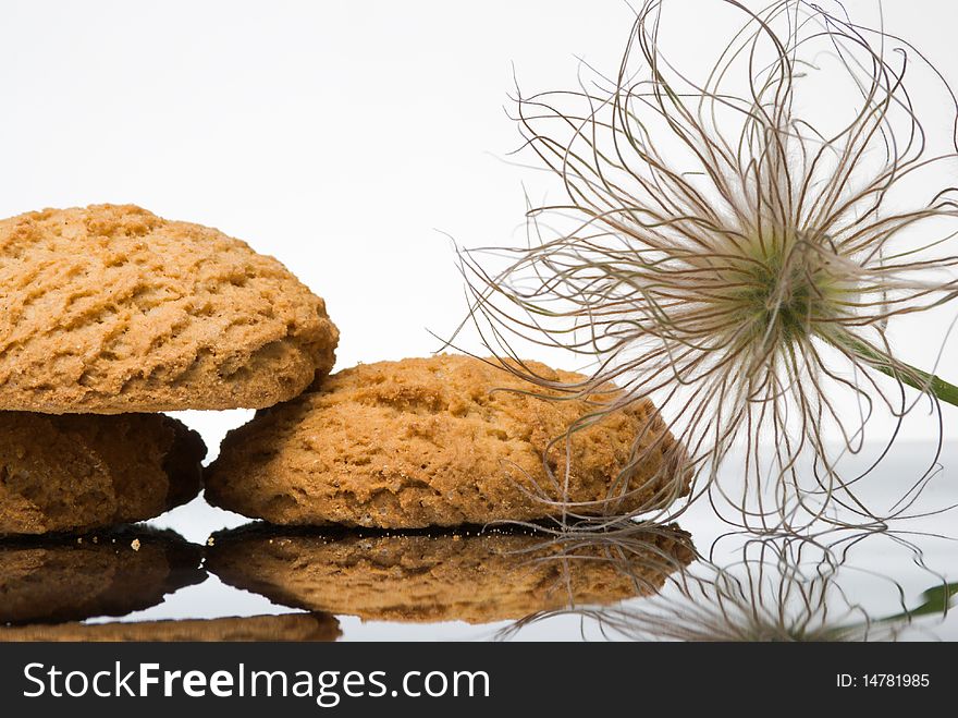 Oaten cookies and puff on reflective surface